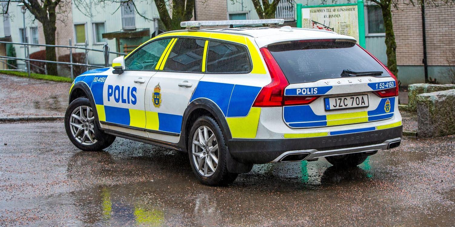 En polisbil parkerad i regnet. 