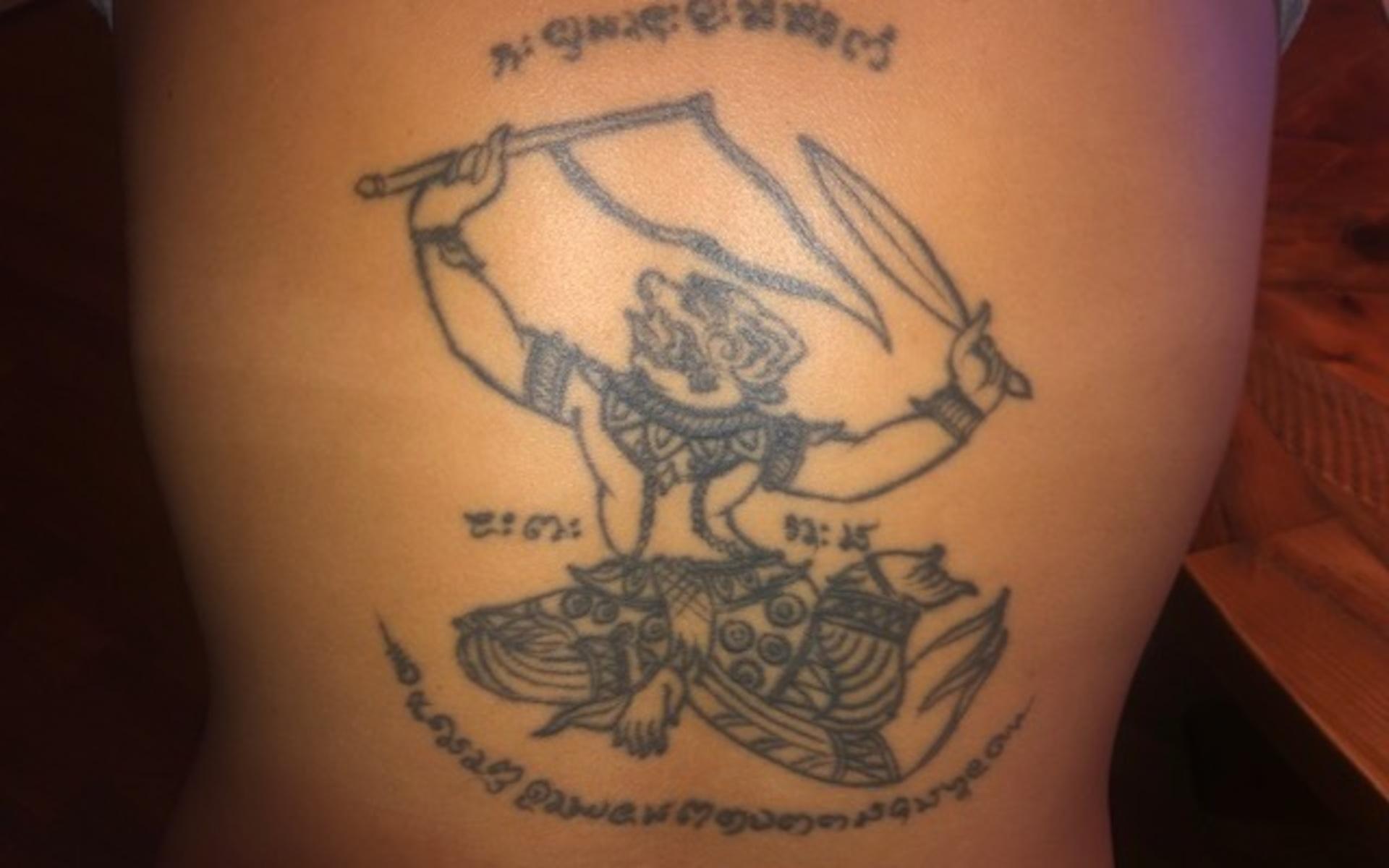 Bom Börjesson skriver: ”Min tatuering betyder att jag alltid är beredd (vänsterhand som håller i svärdet), att jag går i mål (höger hand som håller i flaggan) och aldrig ger upp.”